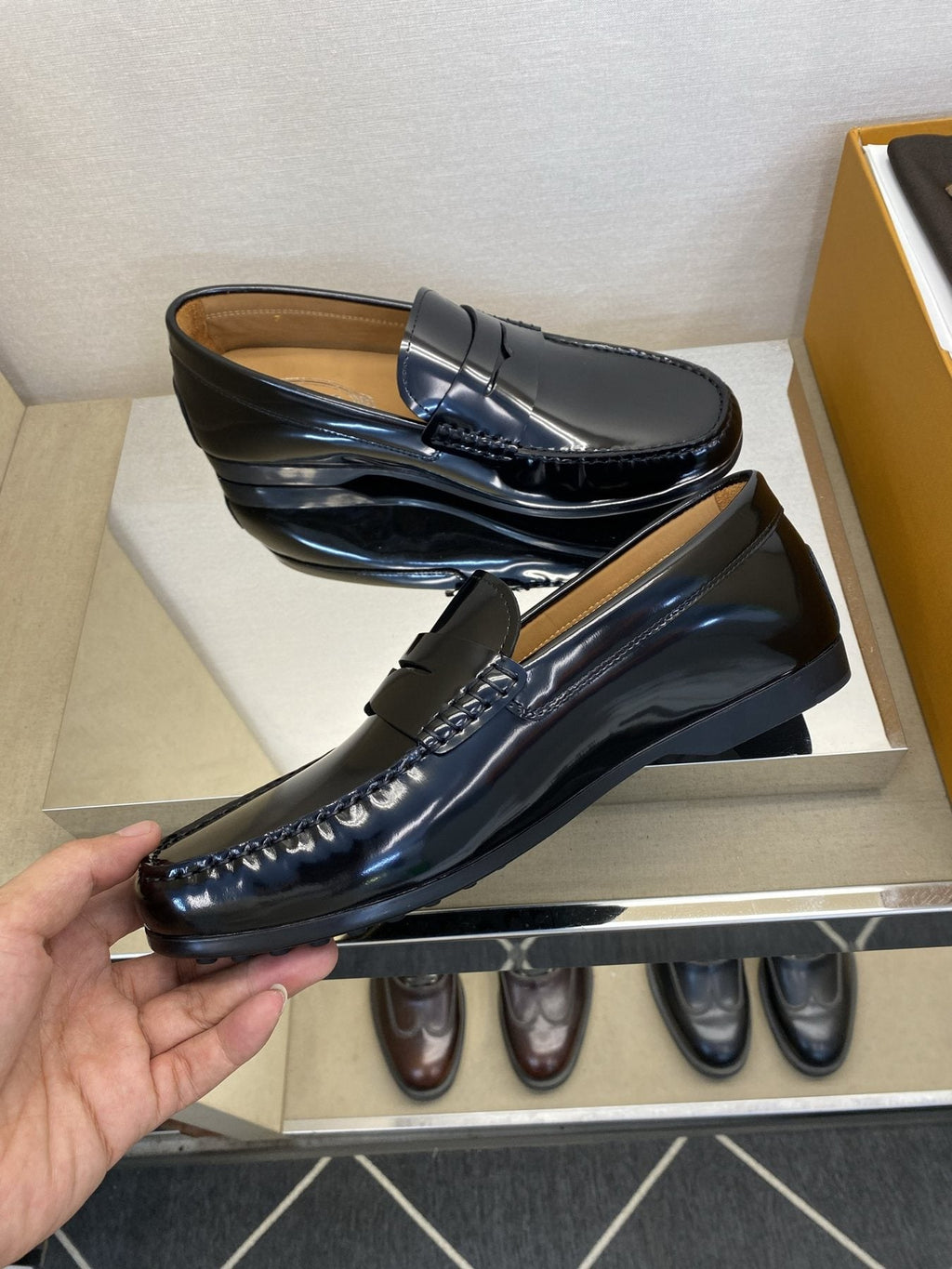 Tod's Glossy Dark Navy Penny Loafers — model