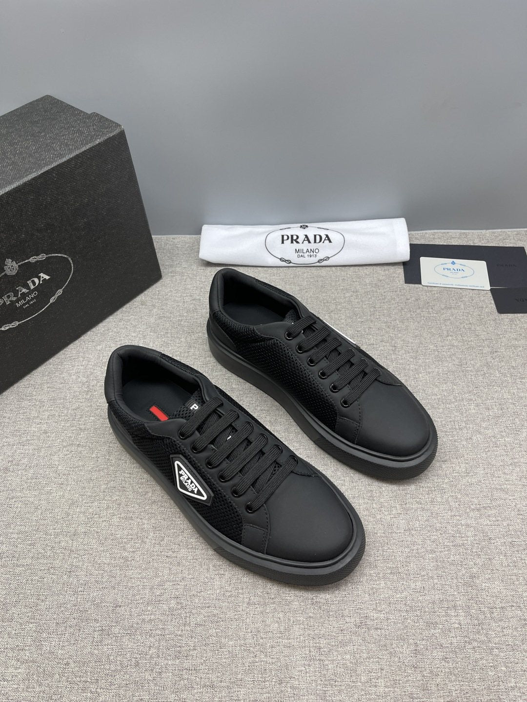 Prada Triangle Patch Low-Top Sneakers — front
