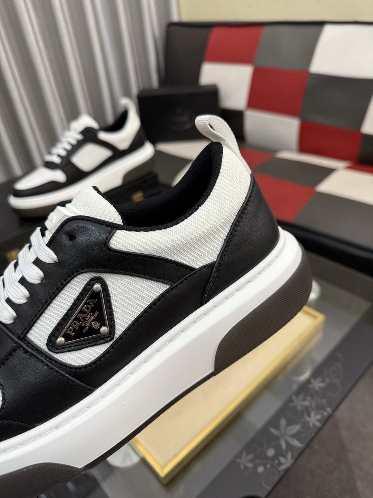 Prada Triangle Plaque Low-Top Sneakers — detail